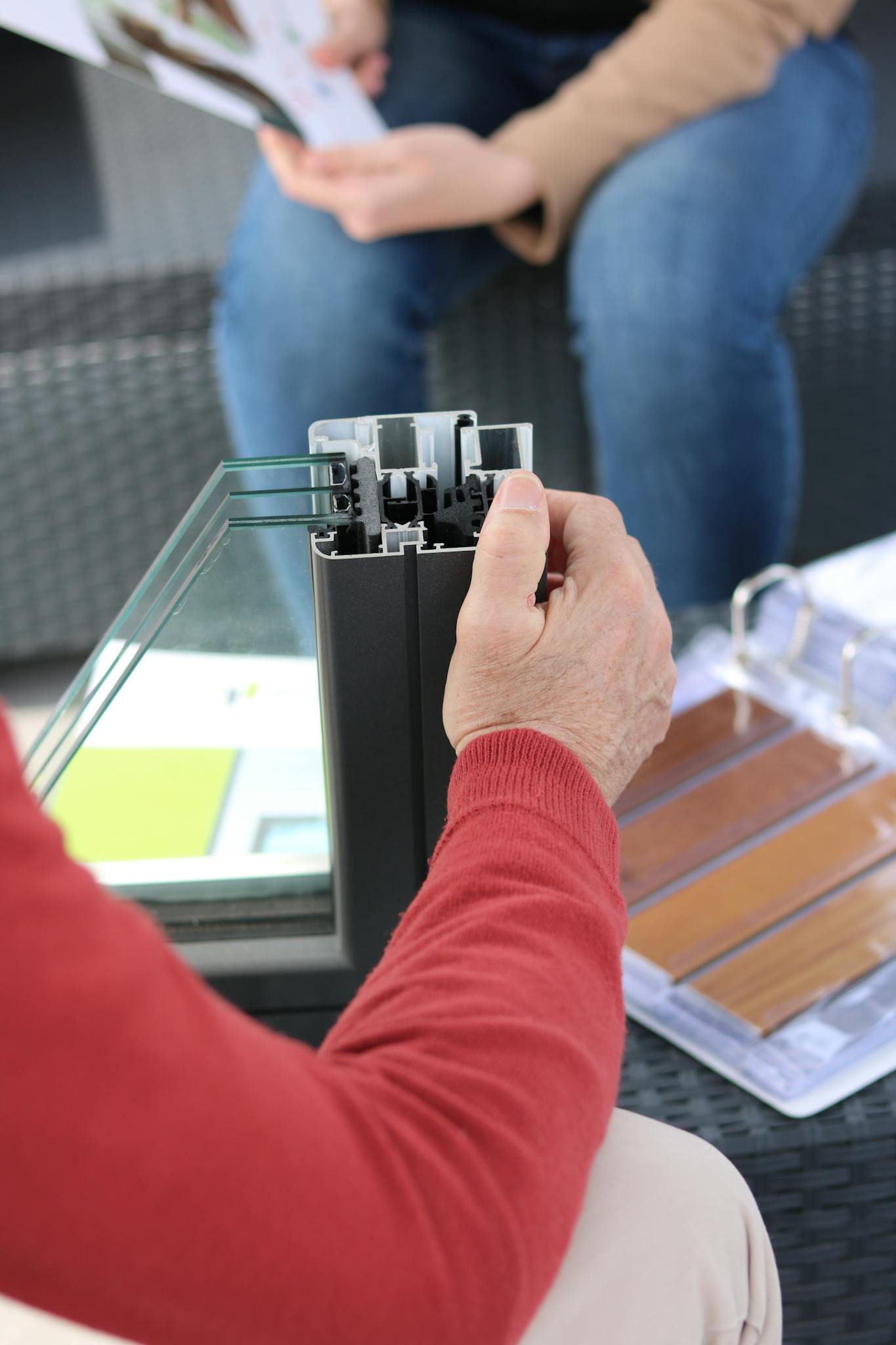 Construction worker examining aluminium fixture for building project indoors.